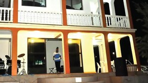 A two-story building with a balcony on the upper floor, a door on the ground floor, and a drum set visible outside. - Dorabo Tourist Hotel (Jinja)