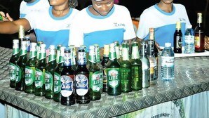 A table with various bottles of beverages, including multiple brands of beer and water. - Dorabo Tourist Hotel (Jinja)