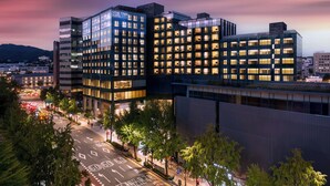 A modern hotel with multiple floors, large windows, and a well-lit facade. - NINE TREE BY PARNAS SEOUL INSADONG (Seoul)