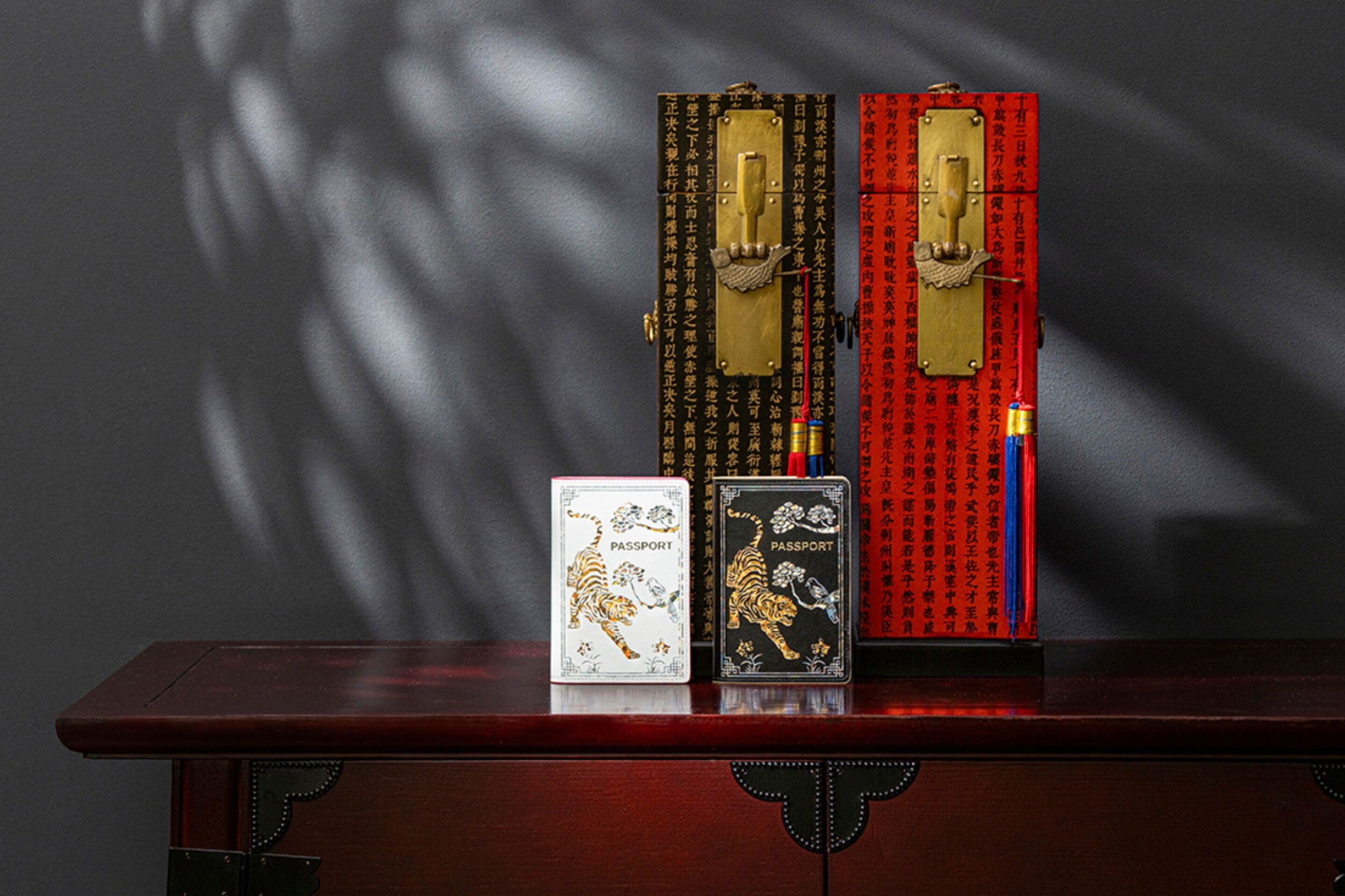 A wooden table with two passports and a card on it.