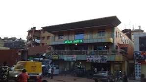A building with a sign reading "Vegas Hotel" and a shop below advertising "SMK Tyres (U) LTD". - Vegas Hotel (Kampala)