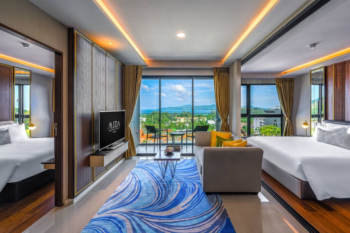 grande 2 bedroom suite ocean view | living area | 49-inch led tv with cable channels, tv, books