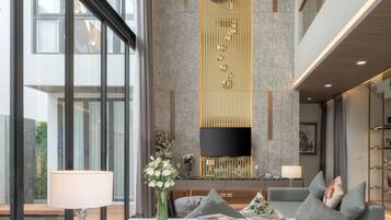 Grande Pool Villa 2 Bedroom | Living area | 49-inch LED TV with cable channels, TV, books