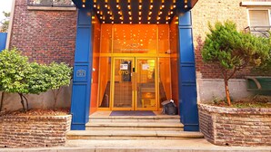 The entrance to OYO5 with a blue facade, glass doors, and a sign welcoming visitors. - OYO Hostel Myeongdong 5 (Seoul)