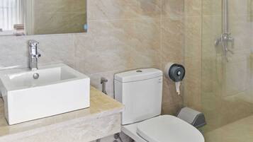 Deep soaking tub, rainfall showerhead, designer toiletries, hair dryer