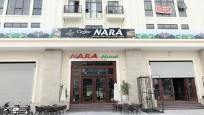 A hotel with a sign reading "NARA Hotel" and a coffee shop sign above it. - Nara Hotel (Kinh Bac)