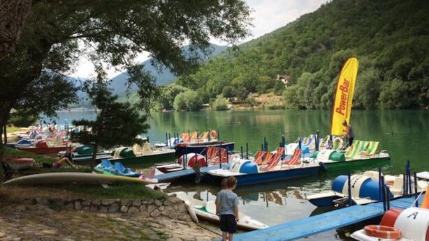 A lakeside dock with boats and a PowerBar flag. - B &B Residence Armonia (Sulmona)