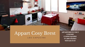 A modern apartment with a kitchen, dining area, and a TV. It includes amenities like a washing machine, a TV with 200 channels, and free WiFi. - Appart Cosy Brest Les Capucins (Brest)