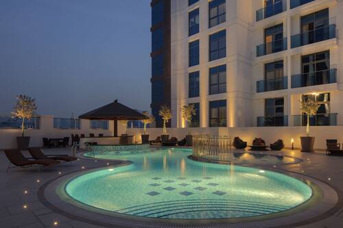 Outdoor pool, open 8:00 AM to 8:00 PM, pool umbrellas