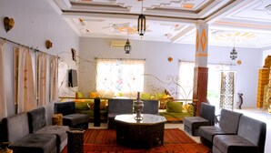 A living room with sofas, a coffee table, and a patterned rug.