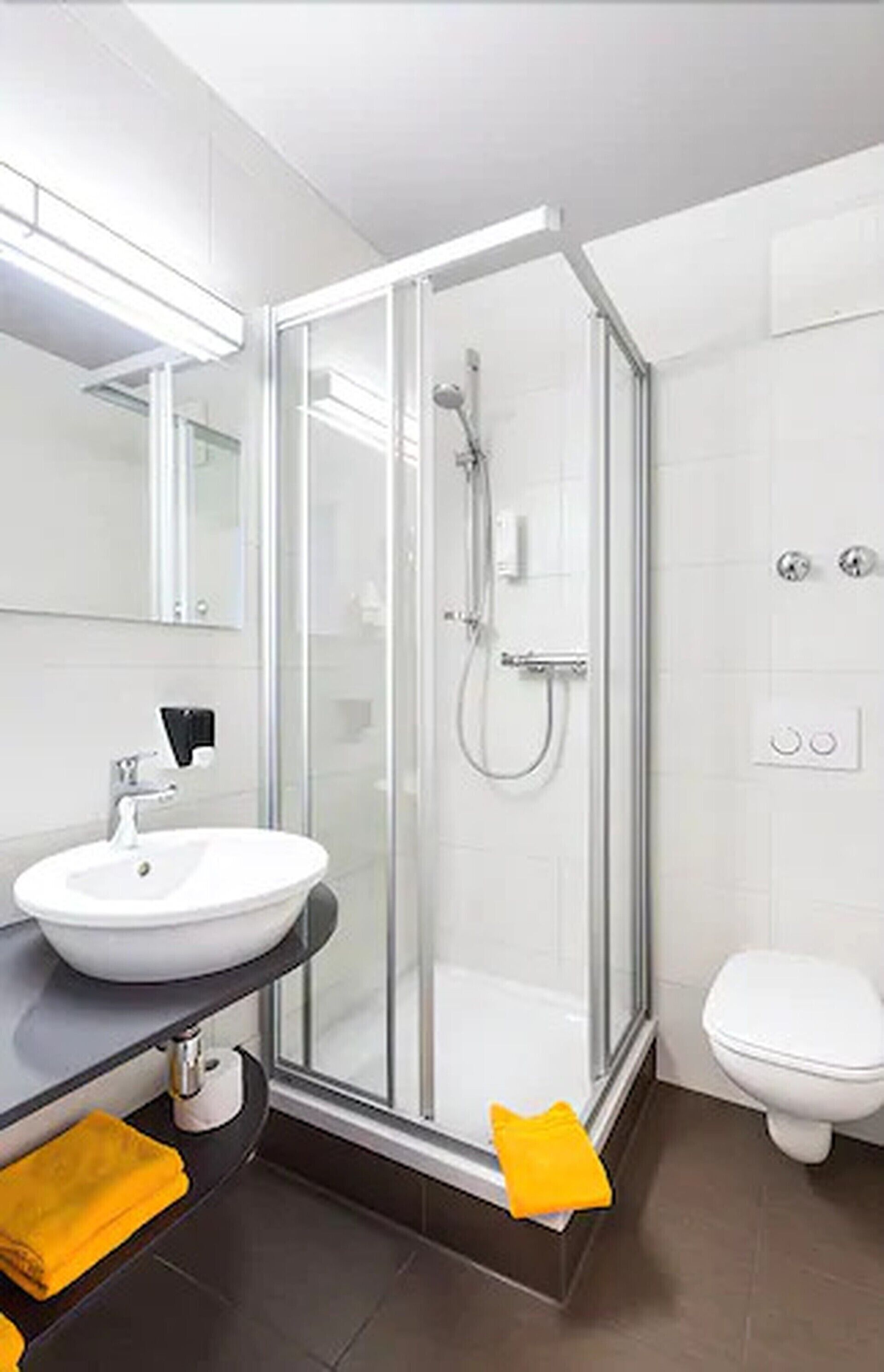 shower, hair dryer, slippers, towels