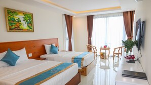 A hotel room with two beds, a desk, a chair, a TV, and a painting on the wall. - Thuy Nga Hotel Phu Quoc (Phu Quoc)