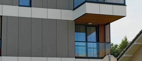 A modern building with a sign for 'Regent Suites.'