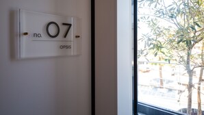 Ein Schild mit der Raumnummer 07 und dem Wort 'OPSIS' an einer weißen Wand.
