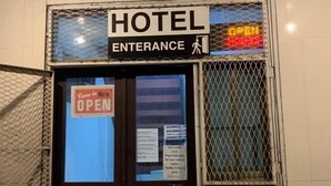 A hotel entrance with a sign indicating it's open. - Hotel Midnight (Paramaribo)