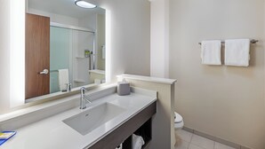 A modern bathroom with a large mirror, a sink, and a toilet. - Holiday Inn Express & Suites Purcell by IHG (Purcell)
