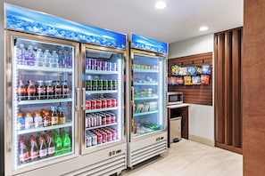 A vending area with various beverage options and snacks.
