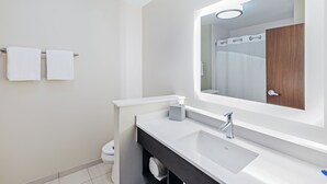 A modern bathroom with a white sink, a mirror, and two towels on a rack. - Holiday Inn Express & Suites Purcell by IHG (Purcell)