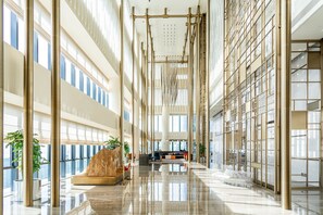 A spacious atrium with high ceilings, large windows, and a central seating area. - Crowne Plaza Shenzhen Nanshan by IHG (Shenzhen)