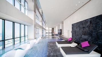 Indoor pool, open 6:00 AM to 11:00 PM, pool loungers, lifeguards on site