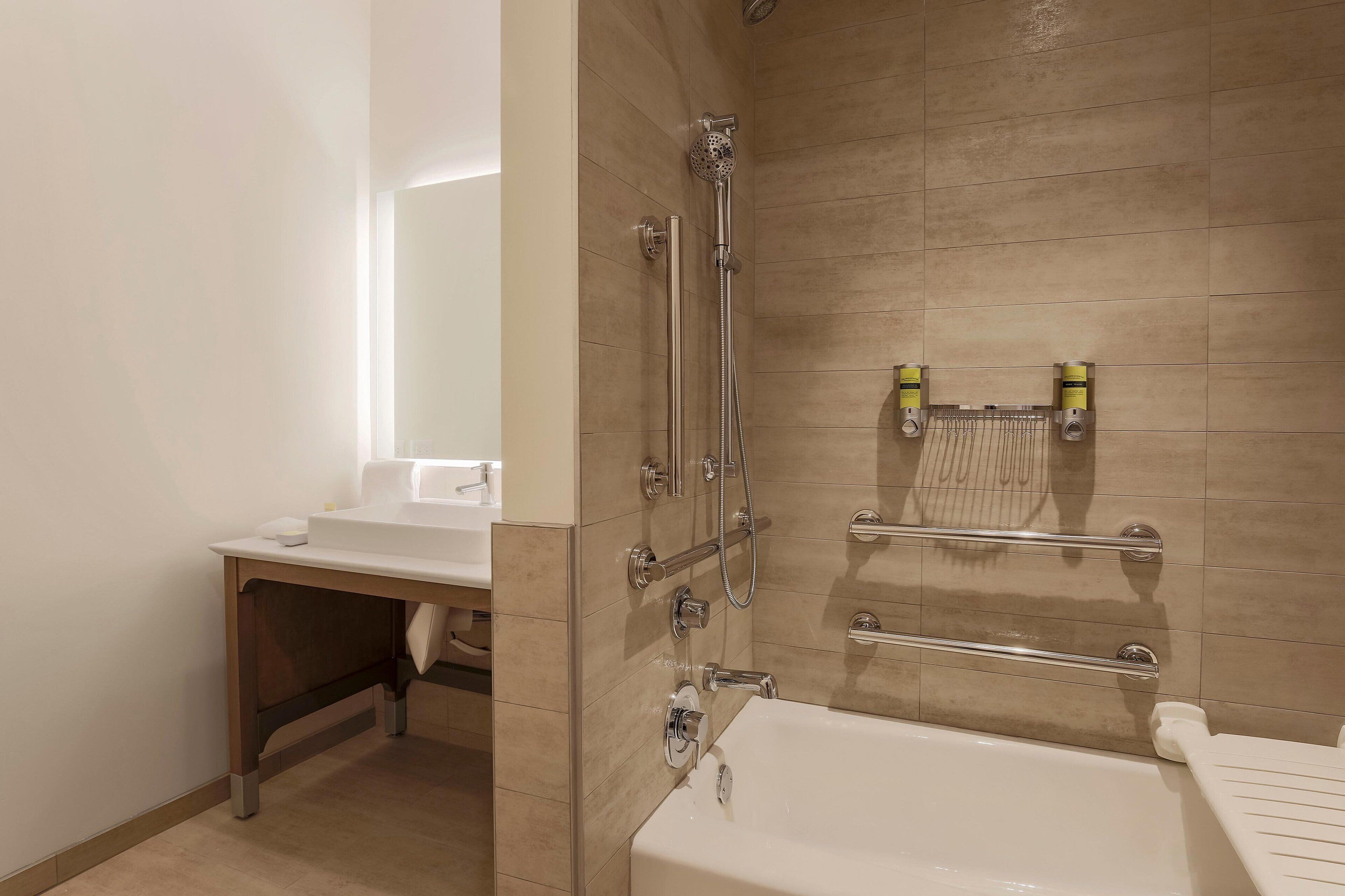 A bathroom with a shower, a bathtub, and a sink.