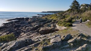 A rocky coastal path with a clear view of the ocean and a distant shoreline. - The Falls at Ogunquit Resort, Maine (Ogunquit)