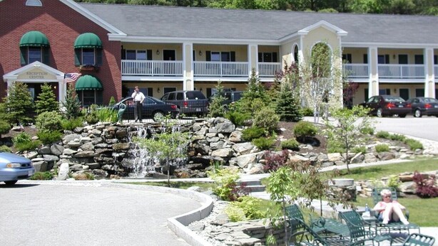 A hotel with a reception center, a stone waterfall feature, and outdoor seating. - The Falls at Ogunquit Resort, Maine (Ogunquit)