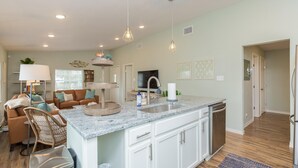 A modern kitchen with a granite countertop, white cabinets, and a built-in dishwasher. - FAMILY FRIENDLY-CLOSE TO BEACH/DT 3 Bed/3 Bath (Rockport)