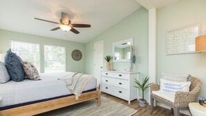 A bedroom with a bed, a ceiling fan, a dresser, a chair, and a potted plant. - FAMILY FRIENDLY-CLOSE TO BEACH/DT 3 Bed/3 Bath (Rockport)