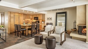 A spacious living area with a kitchen, dining area, and fireplace. - Dog Friendly Aspen Alps Condo walking distance to town with Pool (Aspen)