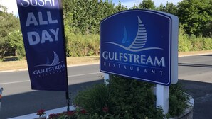 A sign for Gulfstream Restaurant with a 'Sushi All Day' banner.