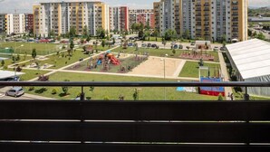 A residential area with multi-story apartment buildings, a playground, and a sports field. - Brasov Holiday Apartments -panoramic 10 (Brasov)
