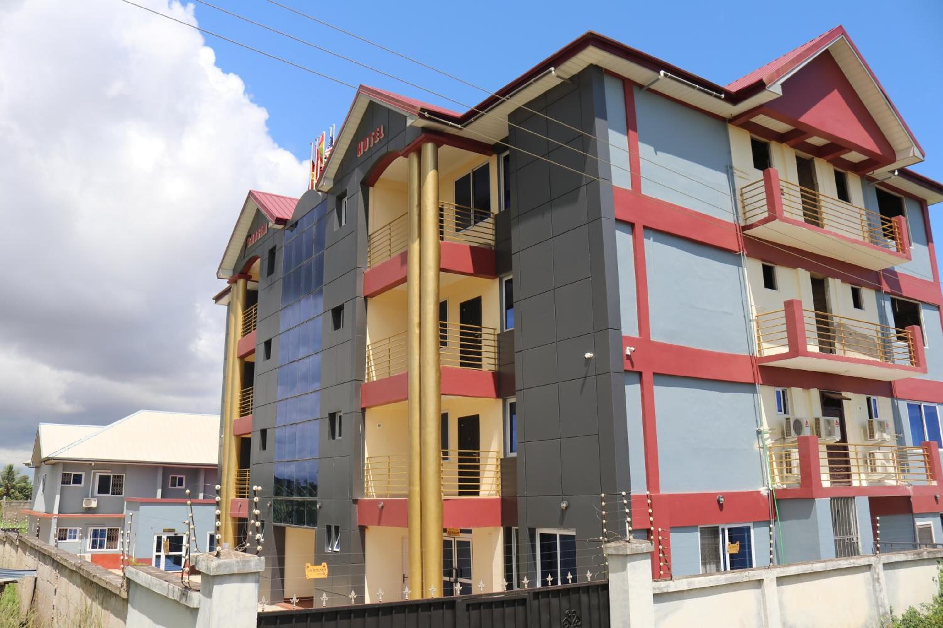 A multi-story hotel with balconies and a central atrium.