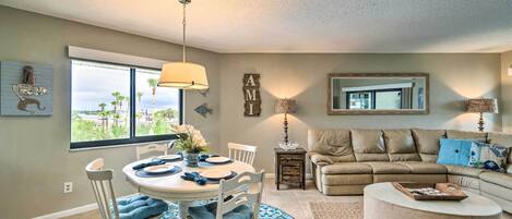 A living room with a dining area, a sofa, and a coffee table.