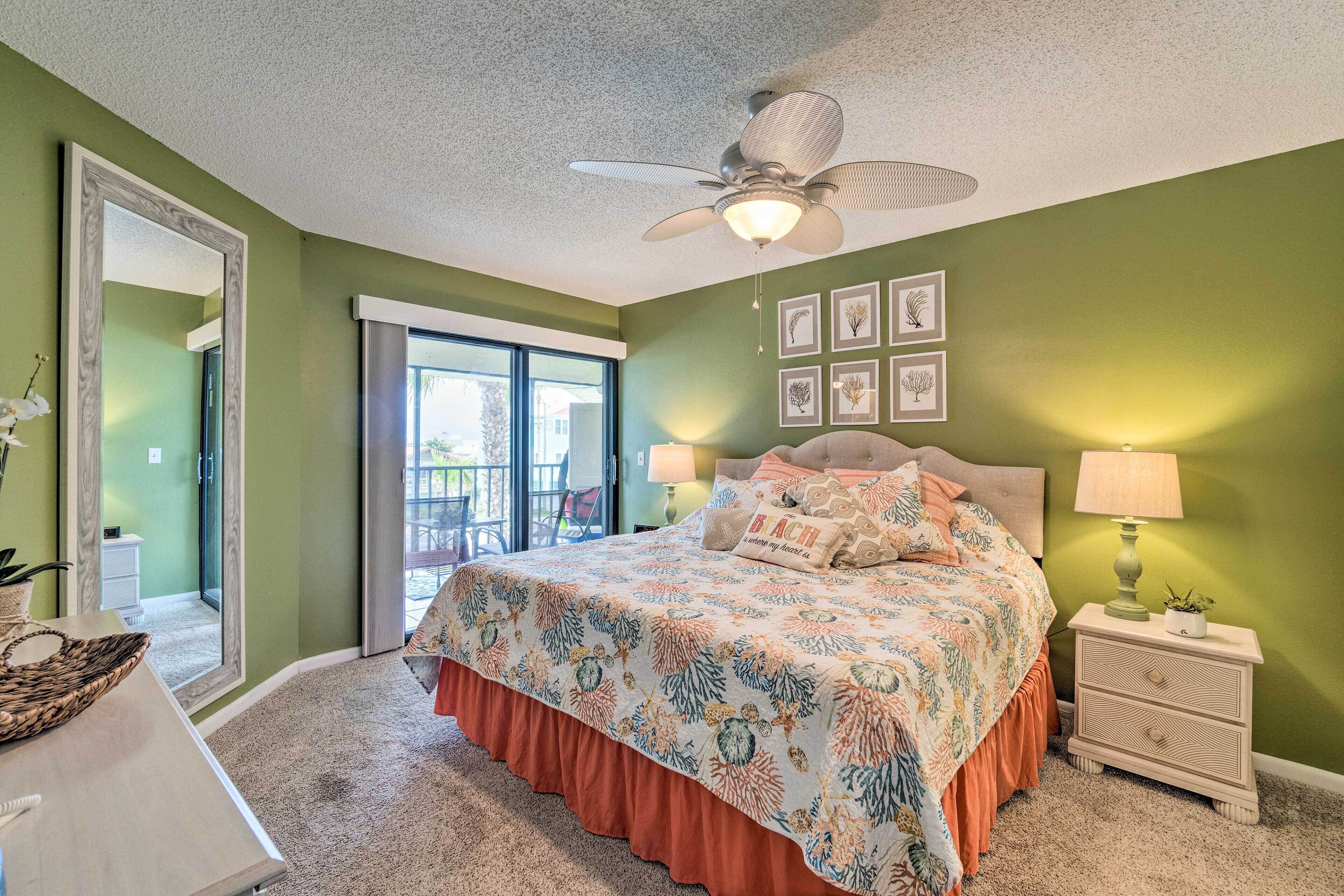 A bedroom with a bed, nightstand, and ceiling fan.