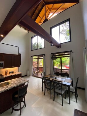 Enjoy meals in this well-equipped kitchen with a large island, dining table, and stainless steel sink.