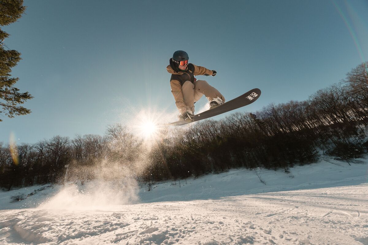 A snowboarder in mid-air performing a jump.
