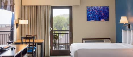 A hotel room with a bed, a desk with a chair, a window with curtains, a painting on the wall, and a balcony with a chair.