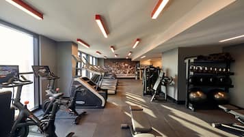 A gym with treadmills, stationary bikes, and weight machines.