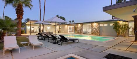 A heated pool, pool umbrellas