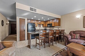 A compact living space with a kitchenette, dining area, and seating area. - Walk to Town Lift| Mountain View Balcony | Hot Tub| Managed by Park City Lodging (Park City)
