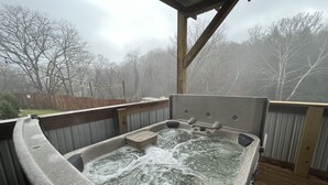 A hot tub with a wooden deck and a view of a wooded area. - Family Time at Hills Hocking @ Pine Creek Villas: Creek Front (Rockbridge)