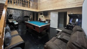A spacious indoor area with a pool table, seating, and a gaming machine. - Family Time at Hills Hocking @ Pine Creek Villas: Creek Front (Rockbridge)