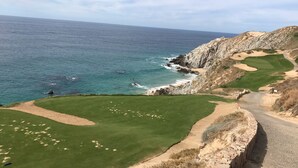 A coastal golf course with a clear view of the ocean and rocky cliffs. - Cabo Private 3bed,3bath Condo + Fober Optic WiFi, Spacious Condo at Quivira Golf (Cabo San Lucas)
