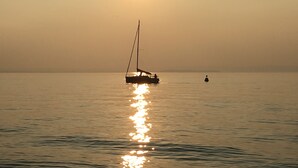 A calm sea with a sailboat and a buoy. - LULLABY HOUSE LAZISE (Lazise)