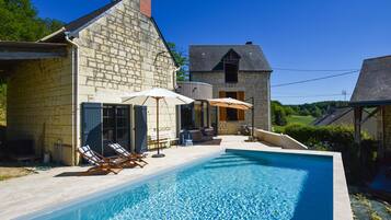 A heated pool, sun loungers