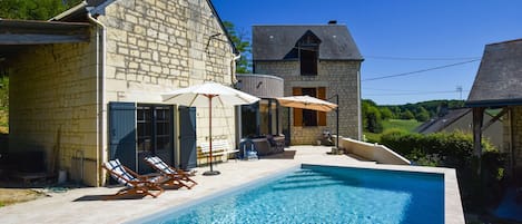 A heated pool, pool loungers