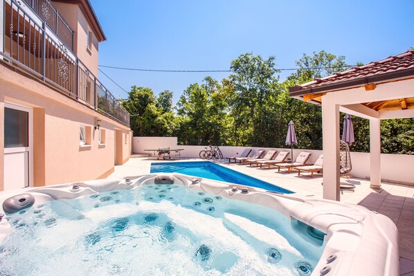 A swimming pool with a hot tub, lounge chairs, and a covered patio area. - Last minute! Luxury villa with heated pool and giant jacuzzi! (Runovici)