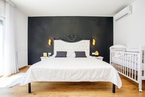 A bedroom with a large bed, a white crib, a dark accent wall, and a window with curtains. - Last minute! Luxury villa with heated pool and giant jacuzzi! (Runovici)