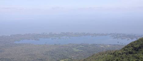 A coastal landscape with dense greenery and scattered islands.